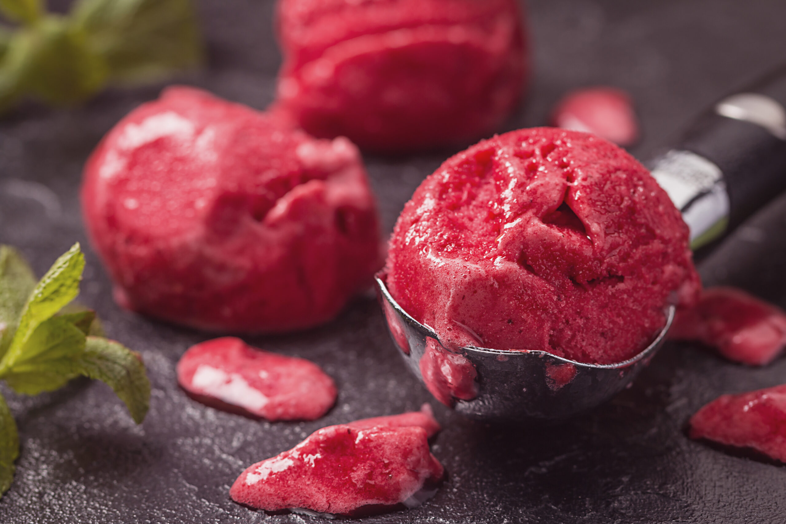 Scoops of premium dairy ice cream colored with BioconColors natural colorants, showing smooth texture and vibrant pastel shades.